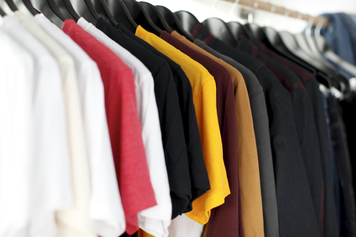 Rack of colorful t-shirts in production