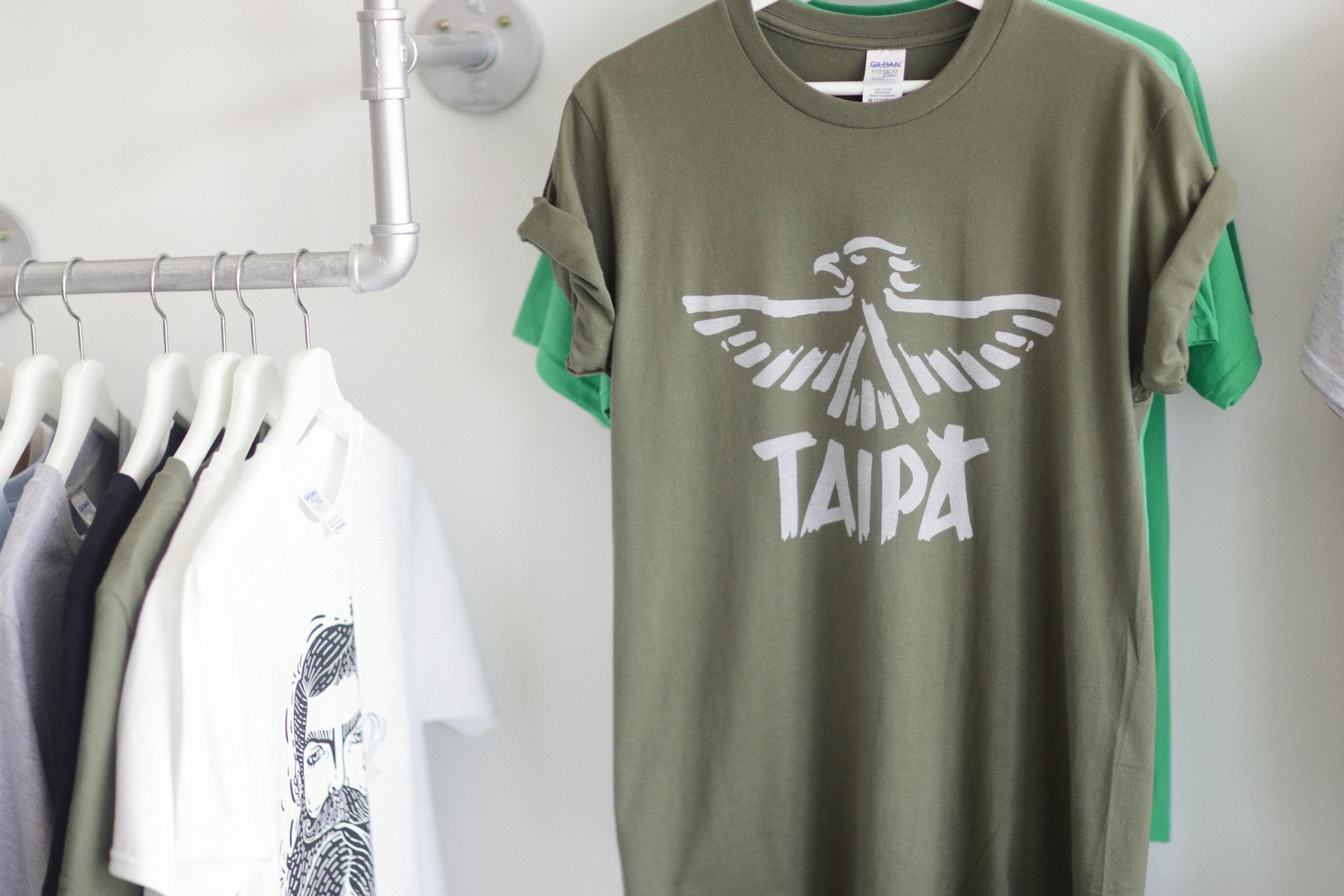 Graphic printed t-shirts hanging on a rack